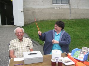 Priscilla trying out a Malaria Fly Swatter on Mahlon 